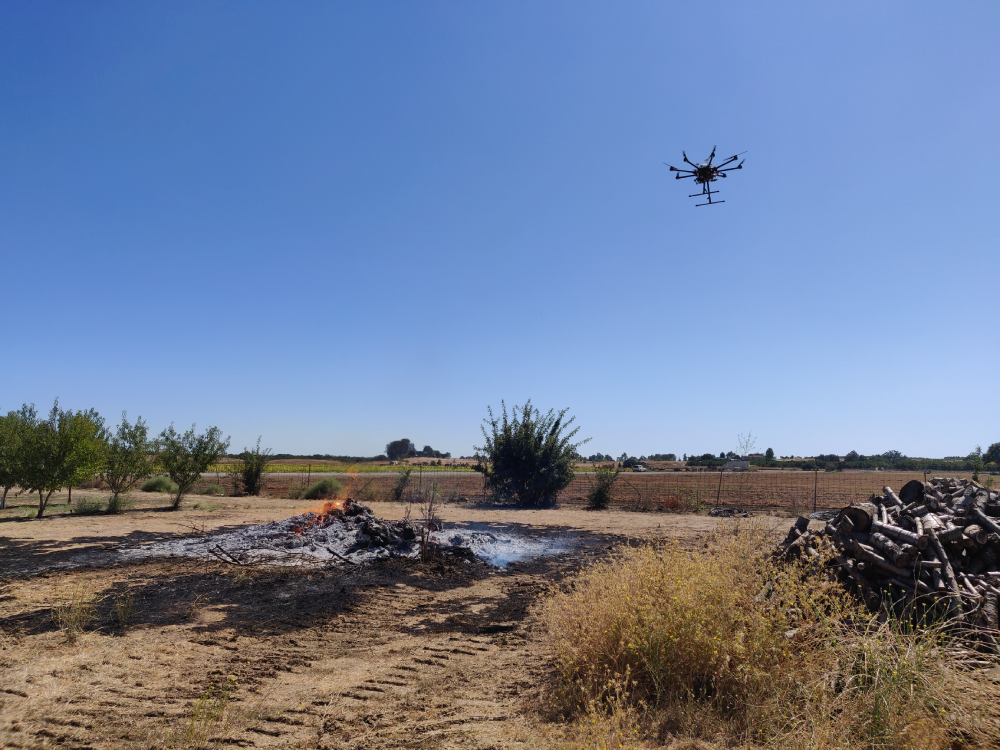 A drone flies near a controlled burn to conduct tests. Mechanical and aerospace engineers at UC Davis think drones are perfect for monitoing the chemical composition and propagation of wildfire smoke. (Zhaodan Kong/UC Davis)