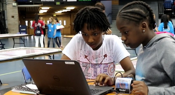 C-STEM girls solving a problem on a laptop