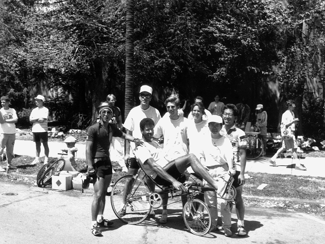 Black and white photo of a group of UC Davis engineers, one is on a bike that reclines